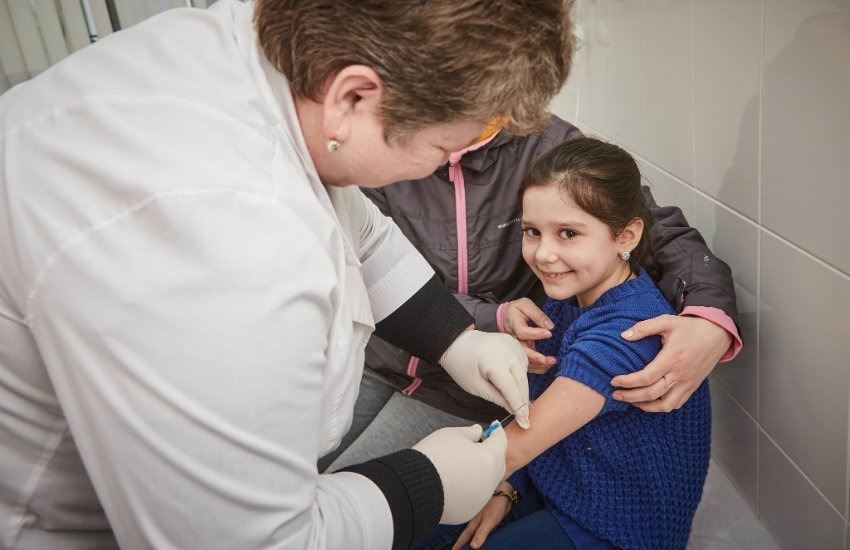 Niña sonríe antes de ser vacunada en Ucrania | Fotografía: Unicef en Flickr. Usada bajo licencia Creative Commons. 